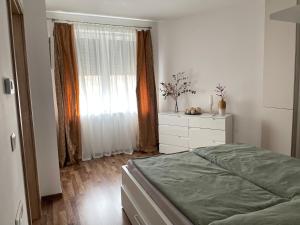 A bed or beds in a room at ERKEL 18 APARTMAN