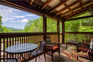 a screened in porch with a table and chairs at Mountain Memories Is A Perfect Mountain Getaway For A Family Or Couples Retreat! in Sevierville