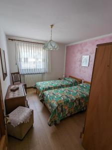 En eller flere senge i et værelse på Auronzo Vacanze di Marina e Valter - Corte 25