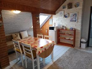 a kitchen with a table and chairs in a room at Karolina Apartment in Békéscsaba