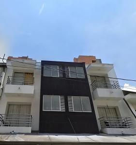 a black building with balconies on the side of it at Emporium Medellín Laureles in Medellín