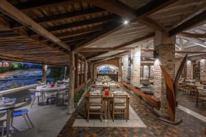 a restaurant with tables and chairs in a building at Hotel Canto das Águas - Roteiro de Charme in Lençóis