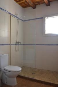 a bathroom with a toilet and a glass shower at Estudio S'ALGA in Sant Francesc Xavier