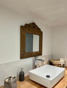 a bathroom with a white sink and a mirror at Maison Jasmin in Gruissan +8 photos