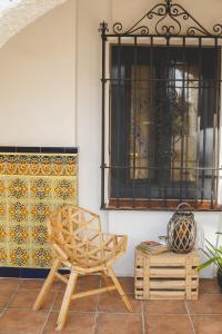 a chair and a table in a room with a window at Casa con encanto in Corbera de Llobregat