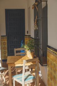 a wooden table and chairs in a room with a door at Casa con encanto in Corbera de Llobregat