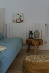 a bedroom with a bed and a table with a tea kettle on it at Casa con encanto in Corbera de Llobregat