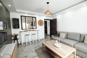 a living room with a couch and a table at Royale Lumineux Jacuzzi Parking privé in Mulhouse +50 photos