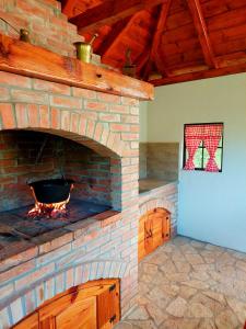 a large brick oven with a fire in it at Vikendica River Uvac in Rudo