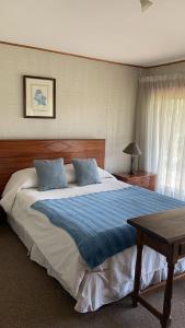 Säng eller sängar i ett rum på Casa tranquila y central con piscina en Olmué