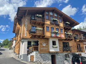 a wooden building with balconies on a street at Schindler in Sankt Anton am Arlberg