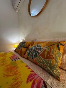 a bedroom with a bed with a colorful blanket on it at Residence Mona Lisa bord de mer Menton in Menton
