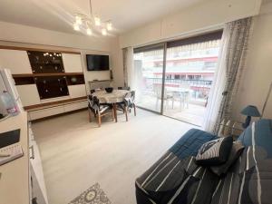 a living room with a table and a dining room at Residence Mona Lisa bord de mer Menton in Menton