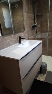 a bathroom with a sink and a shower at Les Chalets en Ruynes 2 in Ruynes-en-Margeride +13 photos