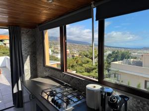 a kitchen with a stove and a view of a city at Atico Valentina in El Paso +8 photos