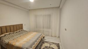 a small bedroom with a bed and a window at Le flamand du lac 2 in La Goulette