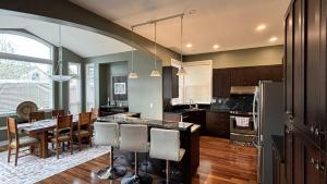 a kitchen with a table and a dining room at Metropolitan Dream Stay with Cozy Fireplace and Hot Tub in Surrey