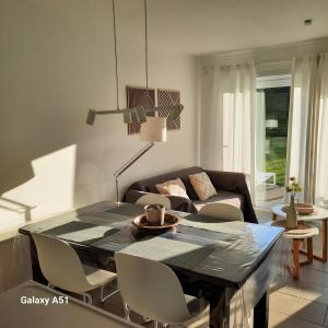 un soggiorno con un tavolo e un divano di Green Garden a De Haan