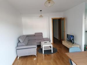a living room with a couch and a table at Apartamento Mar-Azul in Laxe