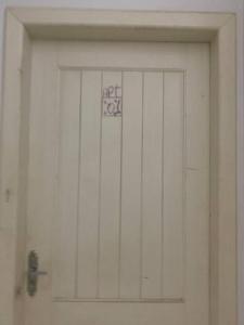 a white garage door with a sign on it at Apartamento Cidade Nova in Paragominas +2 photos