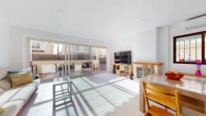 a living room with a couch and a table at El Olivo and Brisas Beach house in Gran Alacant