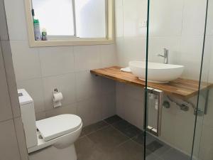 a bathroom with a toilet and a sink at D108 Fantastic Sun Crescent Gathering in Sunshine +19 photos