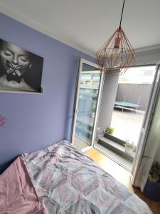 a bedroom with a bed and a large window at Sweet Lori Apartment in Ljubljana