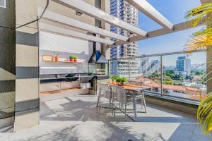 a balcony with a table and chairs and a view of a city at 717 - Rentaqui Studio Elegance Butanta in Sao Paulo