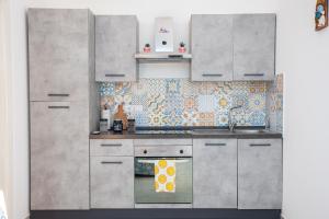 a kitchen with stainless steel cabinets and a stove at Napoli Centro Casa Vacanza in Naples