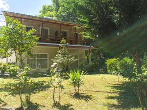 a house with a balcony on top of it at Sotiria Apartments in Kókkinon Nerón