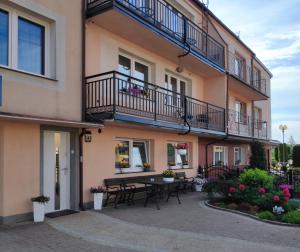an apartment building with a table and balcony at Pokoje gościnne Moli in Łeba