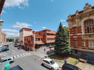 a city street with cars parked in front of buildings at Casa Logroñesa in Logroño