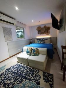 1 dormitorio con 1 cama y 1 sofá en Apartamento no Hotel Porto Marina Mangaratiba, en Mangaratiba