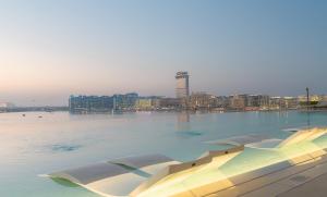 a large body of water with a city in the background at YOUR STAY APARTMENTS in Dubai