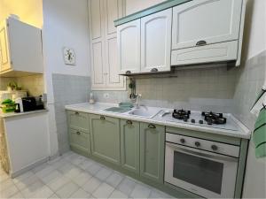a kitchen with white cabinets and a sink at Oasi di Pace in Gaeta