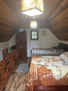1 Schlafzimmer mit 2 Betten im Dachgeschoss in der Unterkunft Pousada Villa Del Bosque - Chalé Familiare in Camanducaia