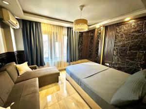 a bedroom with a bed and a couch in it at Golden Prince Hotel Taksim in Taksim