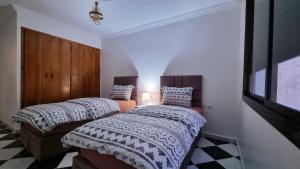 丹吉尔Luxury Sea and Marina View Apartment的卧室里有两张并排的床