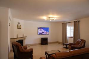 a living room with a couch and a fireplace at Casa vista Arrabida in Cotovia