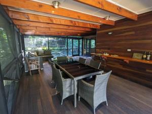 a dining room with a table and chairs at Beachmere Escape in Beachmere