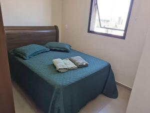 a bed with two towels and two pillows on it at CURTAS DIÁRIAS E ACIMA DE 28 DIAS VALOR MENOR ver in Sao Paulo