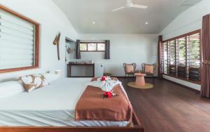 a bedroom with a large bed with flowers on it at Matevulu Lodge in Amseran +33 photos