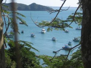 un grupo de barcos en un gran cuerpo de agua en BUZIOS PRAIA PISCINA ePOR doSOL noMar, en Búzios