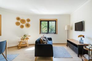 a living room with a couch and a table at Casa de Arouca - Arouca Suítes in Arouca +38 photos