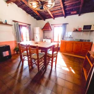a kitchen with a table and chairs in a room at Solar de Campo in Villa Elisa