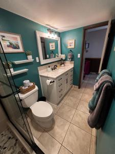 a bathroom with a toilet and a sink and a mirror at Unrivaled S Kihei Maui location! Walk to it all! in Kihei