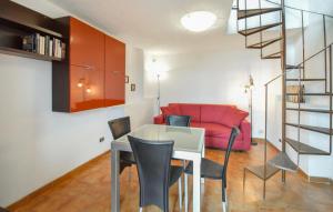 a living room with a table and a red couch at 2 Bedroom Lovely Home In Serrone in Serrone