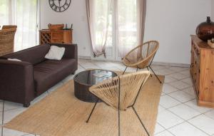 a living room with a couch and two chairs at La Bastide in Grignan