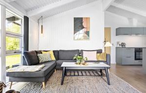 a living room with a couch and a table at Gorgeous Home In Strandby With Kitchen in Strandby