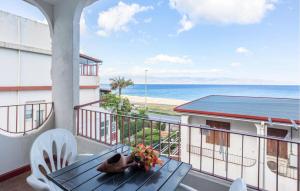 a balcony with a table and a view of the ocean at Cozy Apartment In Messina With House Sea View in Briga Marina